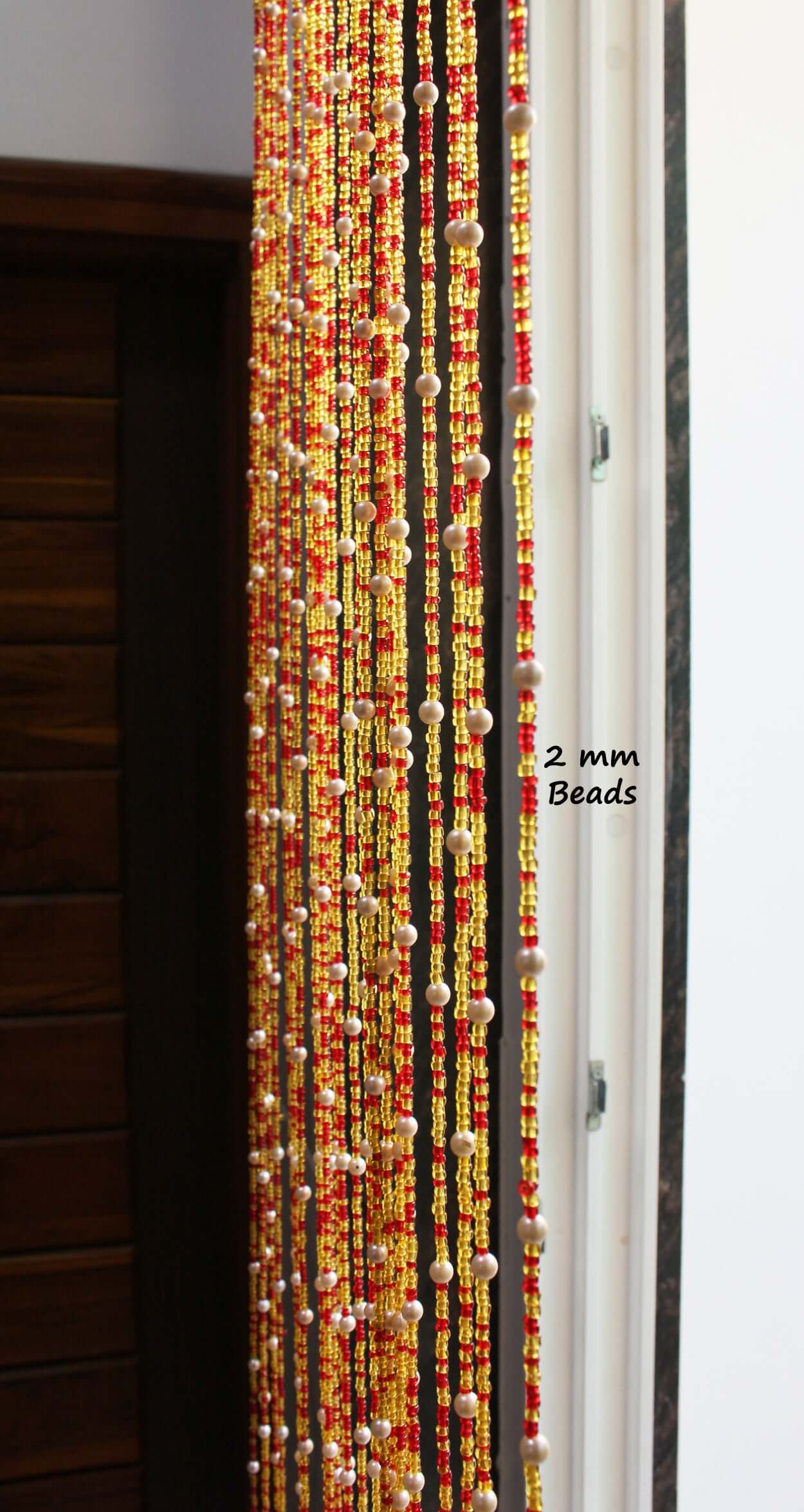 Handmade colorful glass bead strands with jingle bells—perfect for doorways or wall décor. Eco-friendly and crafted by women's artisans in India.